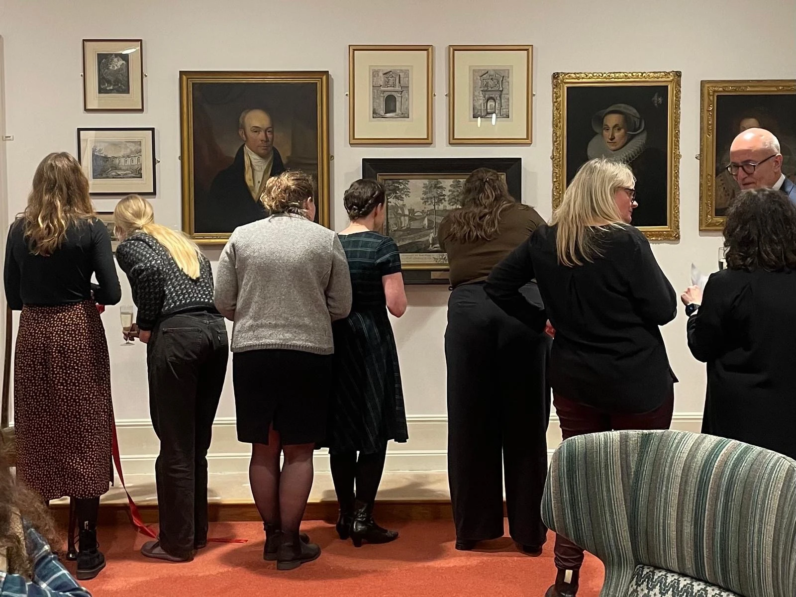 CECS staff and students admiring the art wall